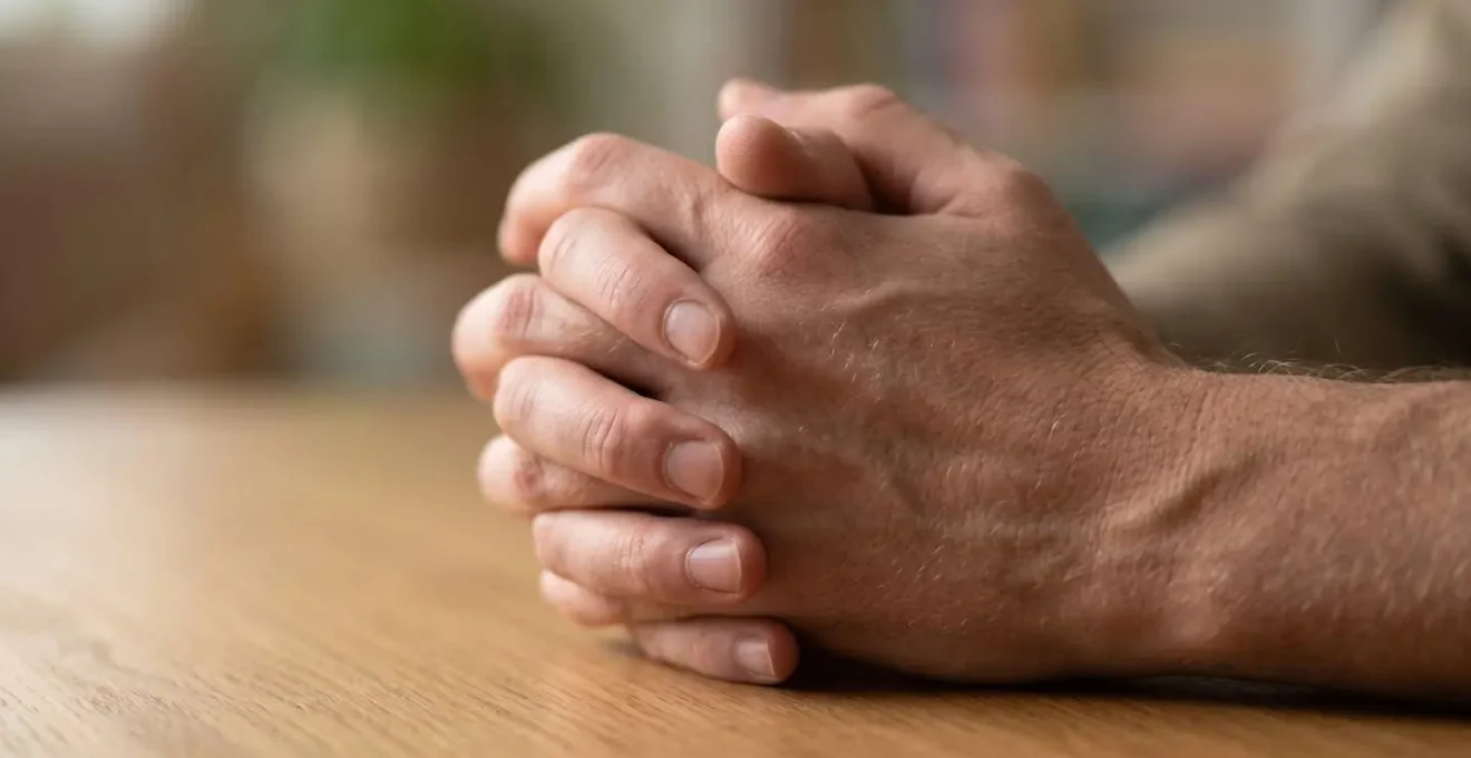 Close-up detail of hands reviewing medical documents in soft natural light suggesting thoughtful decision-making