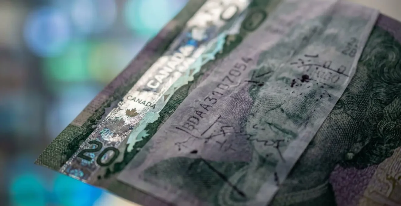 Macro shot of Canadian currency with pharmacy receipt showing cost breakdown