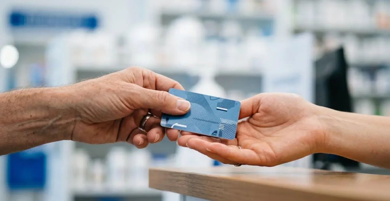 Patient holding Quebec health card during pharmacy transfer process